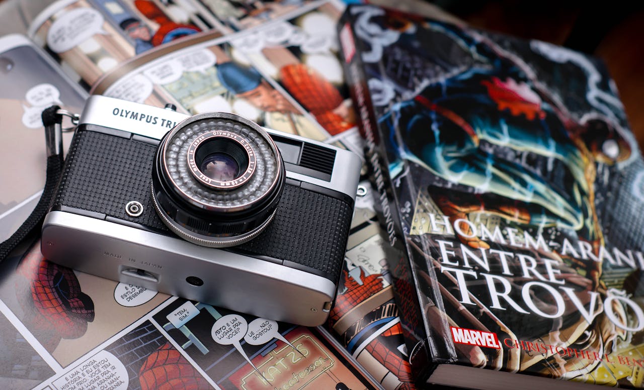 Retro Olympus camera resting on vibrant comic book pages for a nostalgic feel.